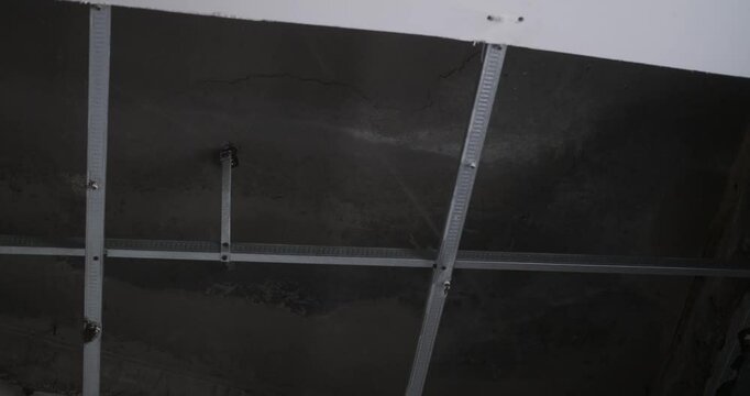 Bottom up view of collapsed plasterboard ceiling, moisture and rust caused a hole in the ceiling. Leak and old house. Need for renovation. Repair of an old house.