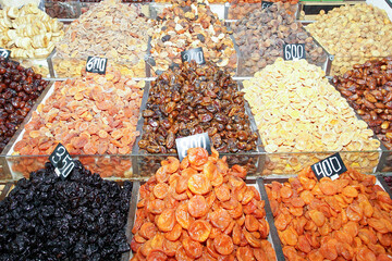 On the market counter in the trays are various delicious and healthy dried fruits.