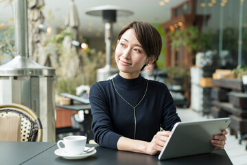 カフェでリモートワークをする30代日本人女性
