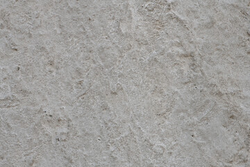Texture of old dirty concrete plaster. Surface of a carelessly smoothed concrete wall or floor with traces of whitewashing, pattern, background, high resolution.