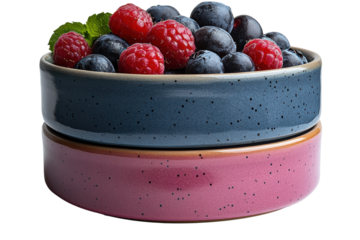 Two stylish bowls filled with fresh blueberries and raspberries, vibrant colors elevate any dining experience.