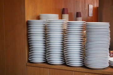 Stacked white plates neatly arranged in a restaurant kitchen area