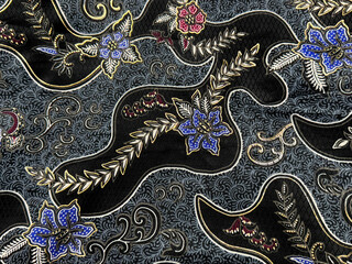 Close up of traditional ethnic random floral and ornamental pattern in shades of blue and black...