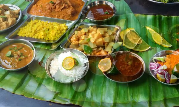 A traditional South Indian meal served on a banana leaf with various curries and rice