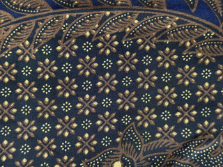 Traditional ethnic fabric in random flower, leaves, swirl, and ornamental pattern. Classic ethnic...