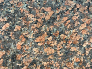Close up of weathered random red brown granite with black grains. Natural open pore red granite stone texture honed for outdoor flooring. Seamless background texture.