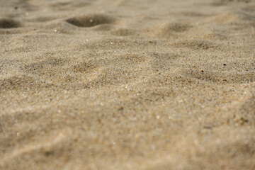 Uneven sand texture, beach background, side view, selective focus