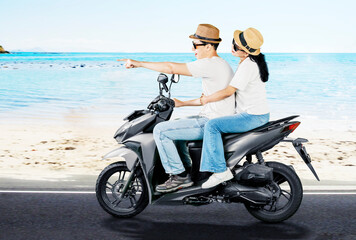 Fototapeta premium Happy Couple Riding Scooter Along Beachside Road on Vacation