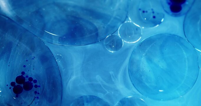 Oil round. Liquid gel. Defocused blue color molecular paint blotch chemical water flow spreading on abstract art acrylic background.