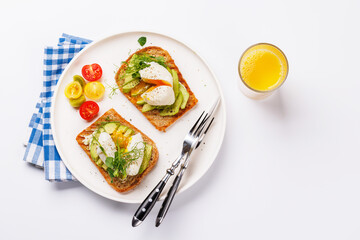 Delicious avocado toasts topped with perfectly cooked poached eggs