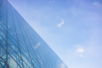 Moerenuma Park's Glass Pyramid Reflecting a Bright Sky with Subtle Clouds in a Minimalist Composition.