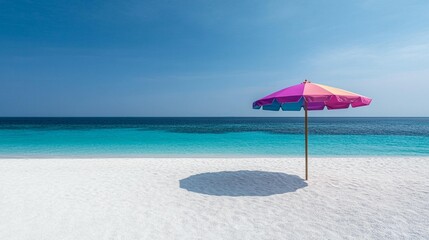 Fototapeta premium Colorful beach umbrella on a pristine white sand beach with turquoise ocean under a clear blue sky.