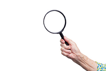 Senior hand grasping a magnifying glass.