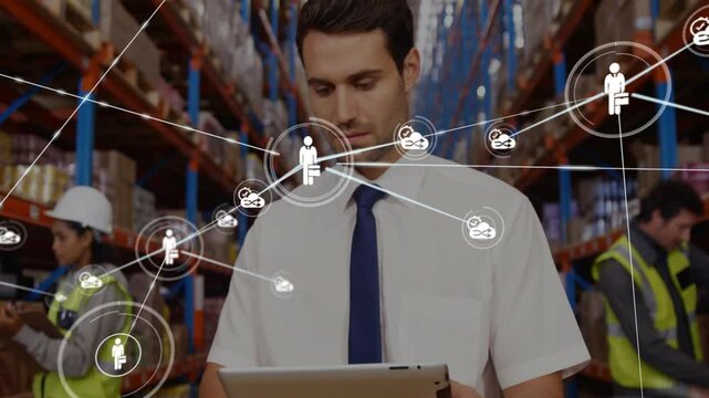 Using tablet with network connections, businessman in warehouse setting - Powered by Adobe