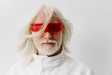 Futuristic elderly man with white hair and beard, wearing red futuristic glasses against a white...