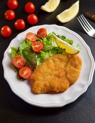 Golden Crispy Schnitzel with Fresh Salad and Lemon Wedges