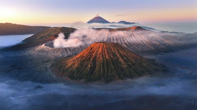 Aerial view flying to mount Bromo at sunrise, active volcano above sea of clouds, Java, Indonesia 
