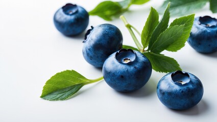 Blueberry isolated. Blueberry accompanied by leaves against a white backdrop. Three blueberries with a clipping path. Complete depth of field. Ideal blueberry, authentic photograph.