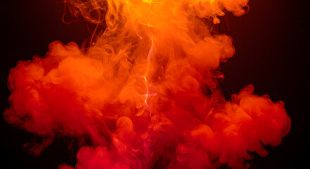Vibrant orange and red ink swirling in water with dramatic lighting on dark background