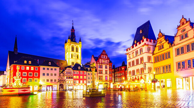 Trier, Germany: Sunset view of the Hauptmarkt, the Main Market. Medieval center of Trier surrounded by historic buildings and St. Gangolf church, Europe