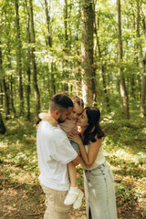 Happy Family Shares a Loving Moment Together in a Forest