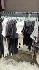 Assorted black and white pants on display in retail store