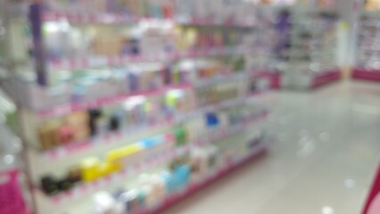 Blurred interior of a brightly lit store with colorful shelves