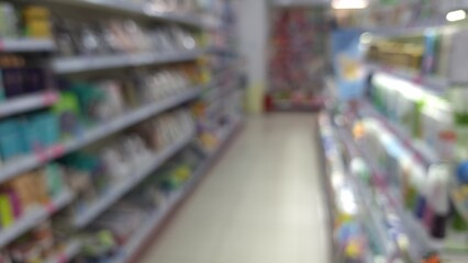 Blurred view of a store aisle with various products on shelves