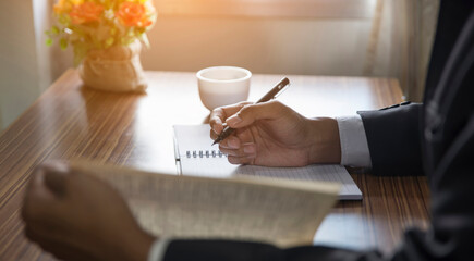 Planner plan Schedule Calendar and reminder agenda, work online at home. Man hand planning daily appointment and write business trip in diary book at office desk. 2025 Calendar reminder event concept.