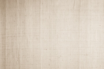 Jute hessian sackcloth canvas woven texture pattern background in light beige cream brown color blank empty.