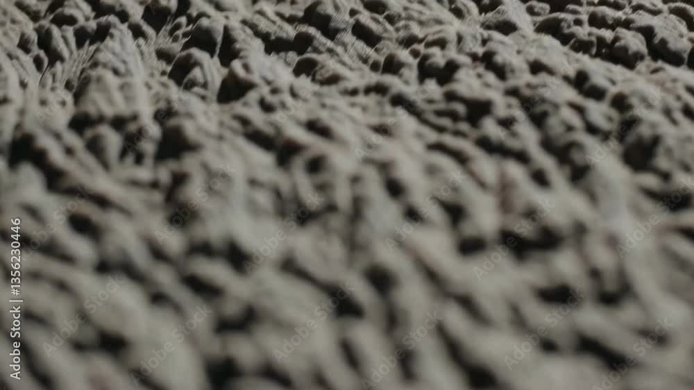 Poster closeup of rough textured surface with changing light patterns