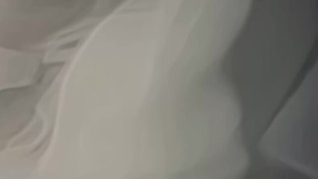 Ethereal white smoke flowing gracefully on soft gray background