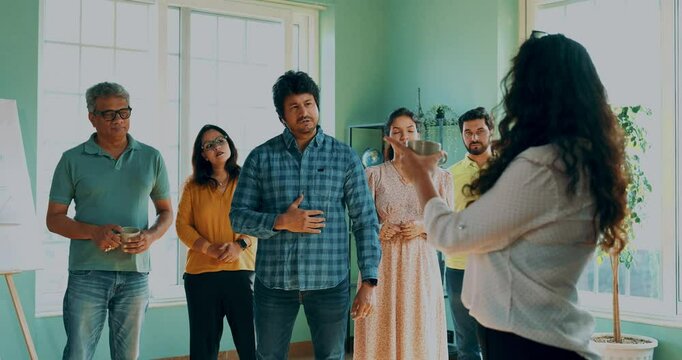 Indian Asian young woman entrepreneur in smart casual wear presenting project brief with slideshow to her happy startup team in modern office, leadership, teamwork, corporate growth, innovation