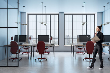 Modern office interior with large windows and city view.