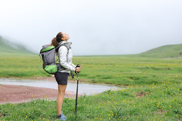 Hiker standing in the mountain breathing fresh air