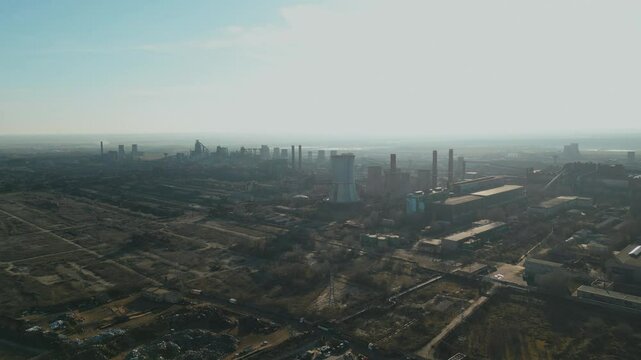 Steel Plant Shrouded In Smog In Galati, Romania. Dramatic Industrial Scene. aerial pullback shot