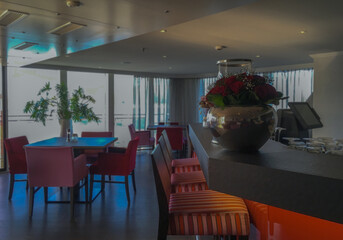 Elegant a la carte speciality dining room restaurant in modern interior design onboard luxury river cruise ship liner with panoramic window views