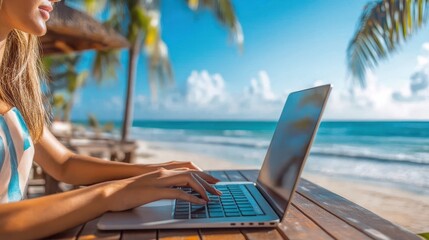 A young woman enjoys the freedom of remote work on a sunny beach, typing away on her laptop with the ocean breeze and palm trees as her office, bathed in bright sunlight and soft sea air.