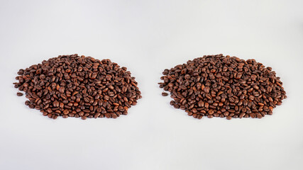 Pile roasted coffee beans isolated on a white background.