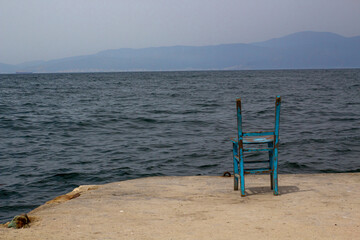 empty chair by the sea. loneliness.