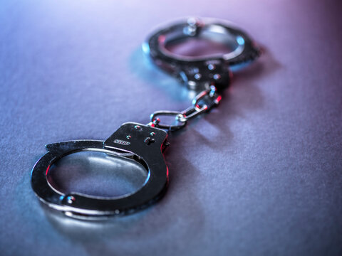 Close-up of metal handcuffs symbolizing justice and crime
