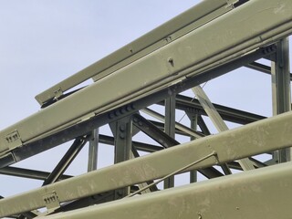 Industrial steel framework with geometric patterns against the sky