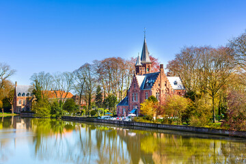 Naklejka premium Panorama with Flemish style building reflecting in Minnewater lake, Bruges, Belgium