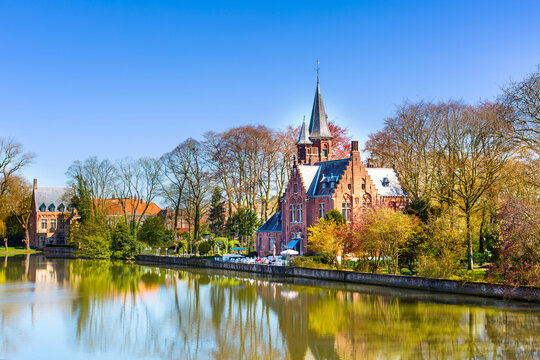 Panorama with Flemish style building reflecting in Minnewater lake, Bruges, Belgium
