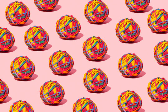 balls of elastic bands, different colors, pattern, on pink background, union concept, mass, lump, agglutination, toy, studio, repetition, group
