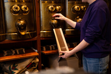 Salesperson packaging coffee beans at a local roastery