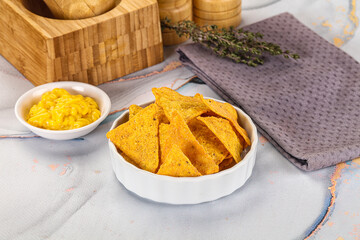 Corn nachos chips with cheese dip