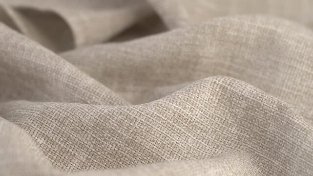 Beige natural fabric rotate in circle. Linen or cotton. Textile material tissue cloth. Texture fabric close up. Fabric background