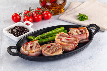 Tasty grilled pork medallion with bacon