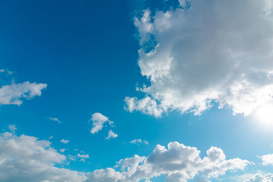Peaceful sky. Tranquil clouds floating over a bright blue backdrop.